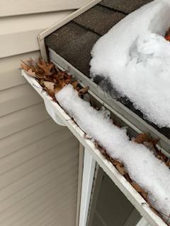 Gutter Cleaning Service Removing Leaves And Snow Buildup From Residential Gutter System